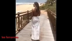 a beautiful woman in a bikini showing her curves Thumb